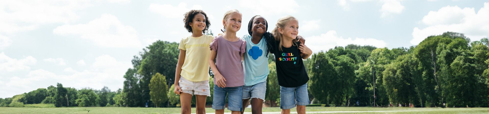  Group of younger Girl Scouts with their arms around each others' shoulders 
