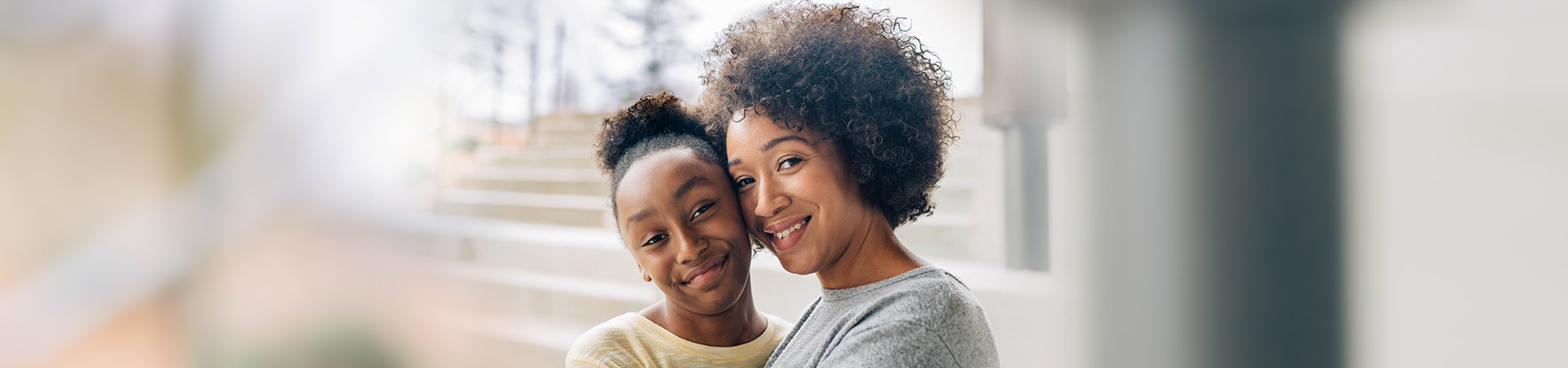  Young Girl Scout hugging mom, both smiling at the camera 